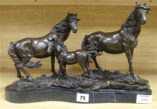 A modern bronze group of a stallion, mare and foal, length 16in.